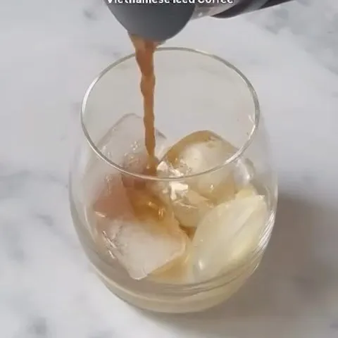 Vietnamese iced coffee being poured