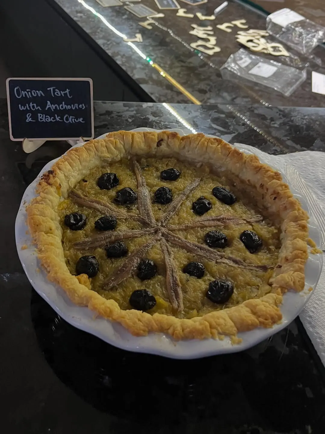 An onion tart with anchovies and black olives from the January French table.