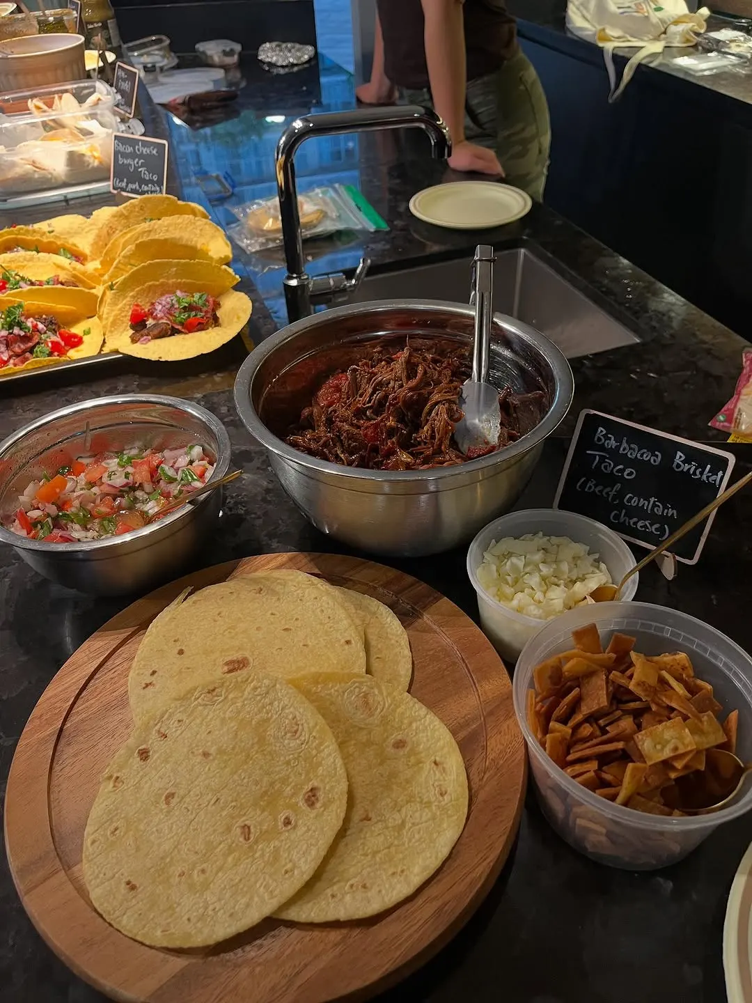 The taco bar at Trejo's Tacos night, with barbacoa brisket, fresh tortillas, and pico de gallo.